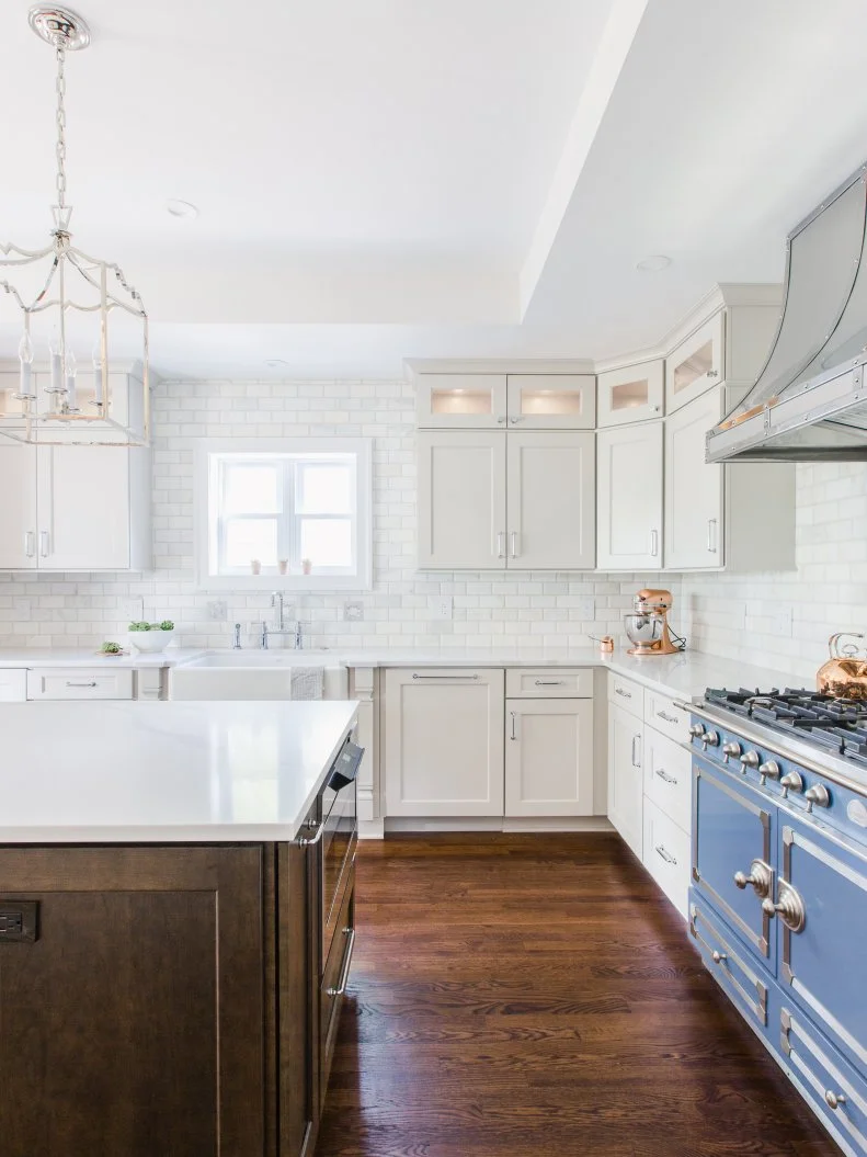 Bright luxury kitchen with white cabinetry and detailed crown molding