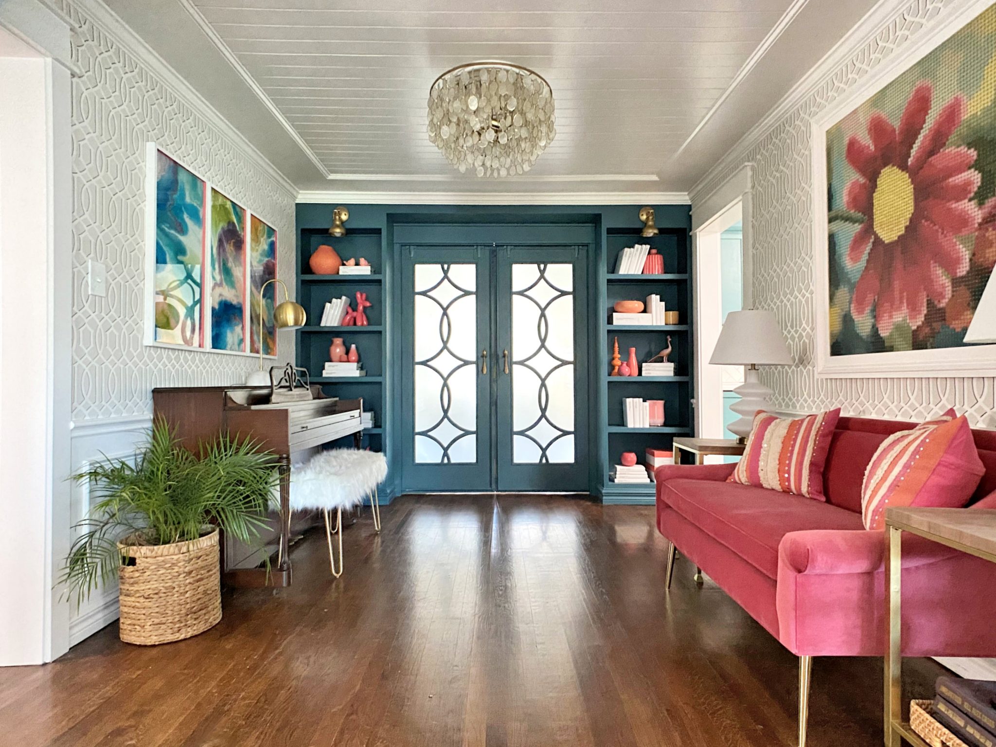 Elegant music room with navy built-ins, gold accents, white crown molding, and a decorative ceiling