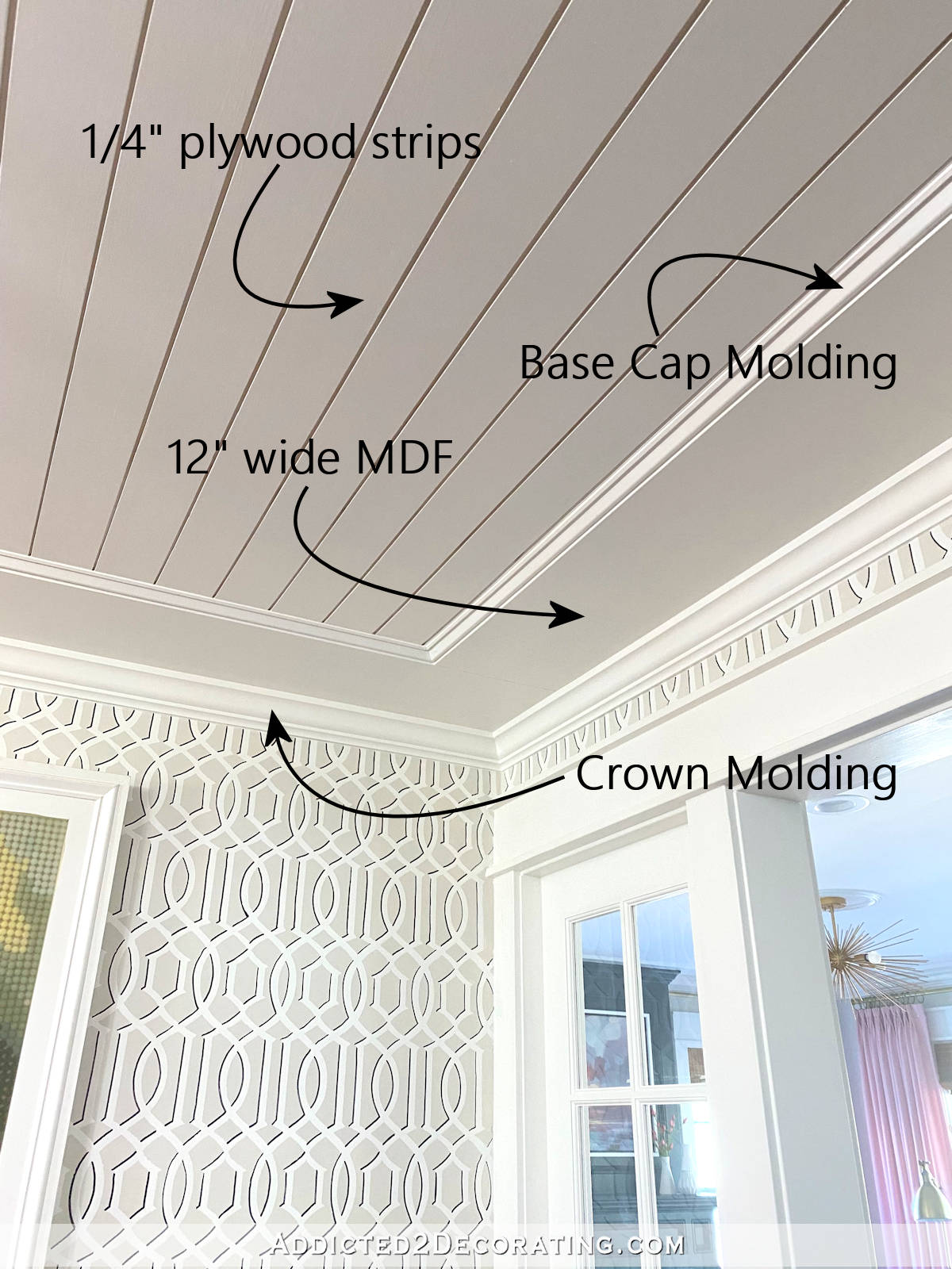 Detailed ceiling showing crown molding, layered trim, and architectural ceiling features